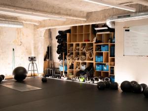 a room with a gym with weights on the floor at Mercure Paris Bastille Marais in Paris