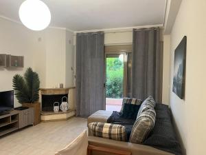 a living room with a couch and a tv at Oikos Apartment in Hanioti