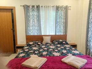 a bedroom with a bed with two towels on it at Cleanslate homestay in Guwahati