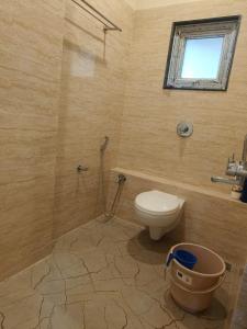 a bathroom with a toilet and a window at Cleanslate homestay in Guwahati