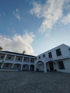 a large white building with a sky in the background at The Royal Gisting - Heritage Hotel in Banjarnegeri +2 photos