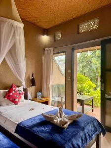 a bedroom with a bed with a bowl on it at Sudi Guest House in Pemuteran