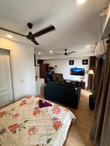 a bedroom with a bed and a living room at neon viman stays in Pune