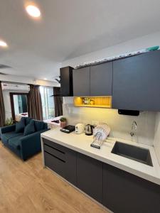 a kitchen with a sink and a living room at neon viman stays in Pune