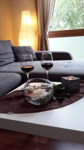 two glasses of wine and a bowl of food on a table at Ferienwohnung Am Korretsberg in Kruft