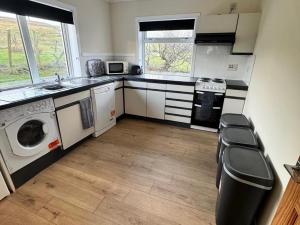 a kitchen with a washer and dryer in it at 2 Borrodale - Sleeps 4 & Beautiful Mountain View in Glendale +11 photos