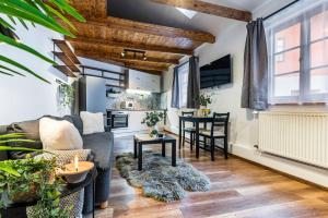 a living room with a couch and a table at Apartmán U Hluboké studny in Rakovník