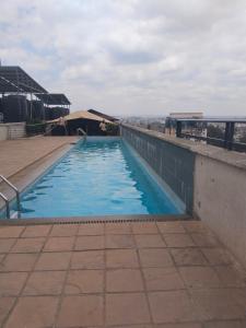 a swimming pool on top of a building at Staycation with Shicks in Nairobi