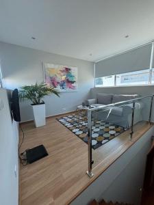 a living room with a couch and a table at Luxury Modern Triplex Apartment in Póvoa de Varzim +9 photos