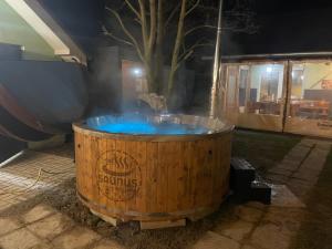 a hot tub in a wooden barrel with a tree at Villa Bodiky in Bodíky