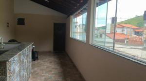 a room with a sink and a large window at Alugo kitnet com café da manhã in Aparecida