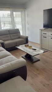 a living room with a couch and a coffee table at Apartament in Suceava