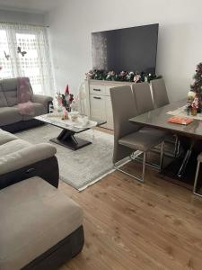 a living room with a table and a television at Apartament in Suceava