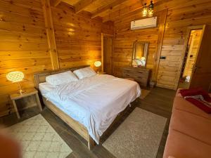 a bedroom with a bed in a wooden cabin at أكواخ كيفاء الريفية in Tabuk +35 photos
