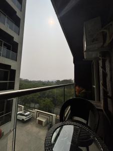 a balcony with a chair and a view of a building at neon viman stays in Pune