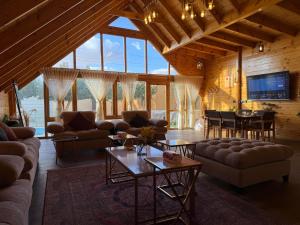 a large living room with couches and a table at أكواخ كيفاء الريفية in Tabuk