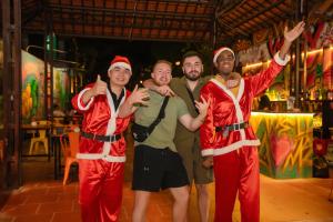 a group of three men dressed in santa claus costumes at Wow Tam Coc Homestay in Vũ Lâm
