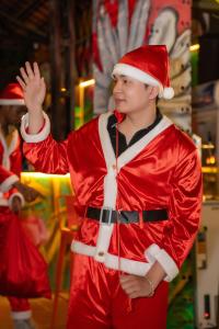 a young boy dressed in a santa claus costume at Wow Tam Coc Homestay in Vũ Lâm +98 photos