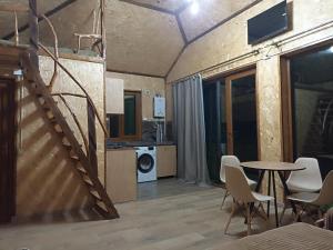 a room with a staircase and a table and chairs at Green Paradise in Ijevan