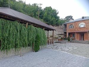 a pavilion with plants on it next to a building at Green Paradise in Ijevan