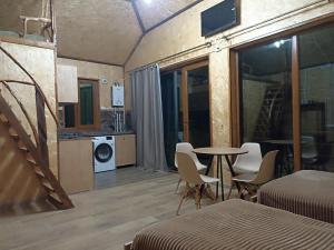 a room with a table and chairs and a kitchen at Green Paradise in Ijevan