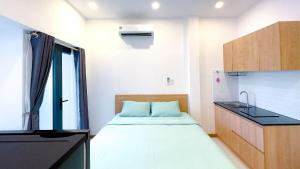 a small room with a bed and a sink at Lunaria Maison - Local Side in Ho Chi Minh City
