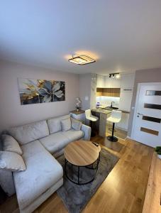 a living room with a white couch and a table at Sweet Home Pale in Pale