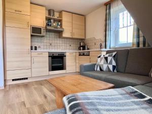 a kitchen with a couch and a table in a room at Knirschenhof in Windischgarsten