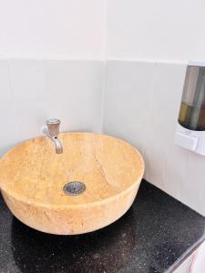 a wooden sink sitting on a counter in a bathroom at Bleu Haven in Kitale +7 photos