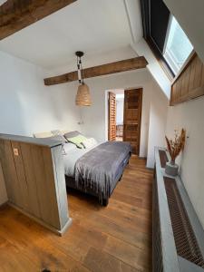 a bedroom with a bed and a vaulted ceiling at Pothuis Zuid in Zandvoort