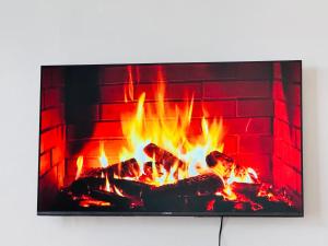a fireplace with flames in front of it at Bleu Haven in Kitale