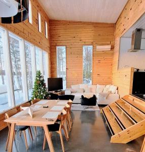 a living room with wooden walls and tables and a couch at Vietos Villa in Jolanki
