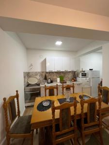 a kitchen with a table and chairs in a room at Famely apartmen in Prizren
