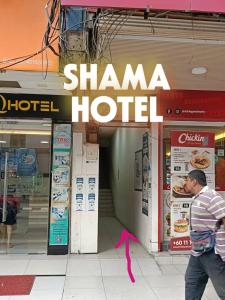a man walking in front of a shanza hotel at SHAMA HoTEL in Kuala Lumpur