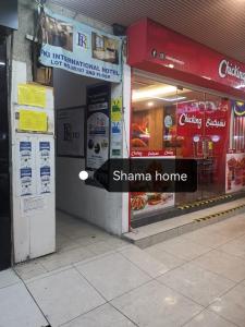 a store front of a sharma home with a sign in the window at SHAMA HoTEL in Kuala Lumpur