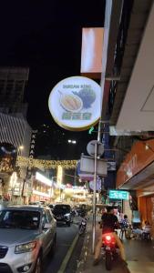 a city street at night with cars and a sign at SHAMA HoTEL in Kuala Lumpur