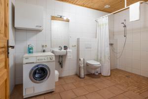 a bathroom with a washing machine and a toilet at Bauernhof Diestel in Oldau +41 photos