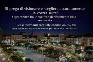 a view of a city at night at Vittorio Emanuele Charming Suites in Monopoli