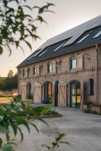 a large brick building with doors and windows at Stodola Rybojady in Rybojady