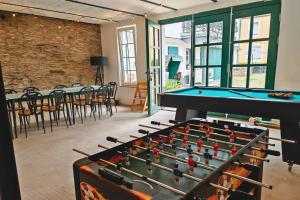 a room with a pool table and ping pong balls at Hofgut Eveshausen - Dreiseitenhof - Spielscheune - Landidylle - Hofleben in Dommershausen