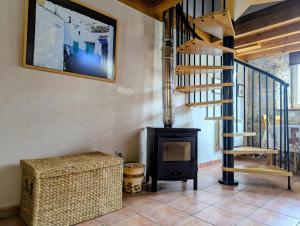 a living room with a staircase and a fireplace at Errotazar apartamento rural P in Alsasua