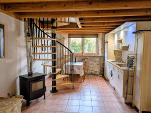 a kitchen with a spiral staircase in a house at Errotazar apartamento rural P in Alsasua