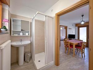 a bathroom with a shower and a sink and a table at BBkey La cjase SOT LA STRETE in Arta Terme
