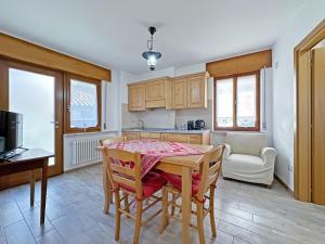 a kitchen with a table and chairs in a room at BBkey La cjase SOT LA STRETE in Arta Terme +15 photos