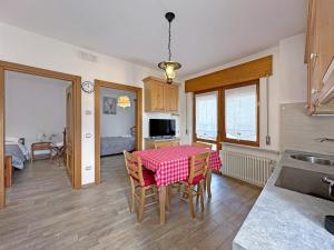 a kitchen and dining room with a table and chairs at BBkey La cjase SOT LA STRETE in Arta Terme