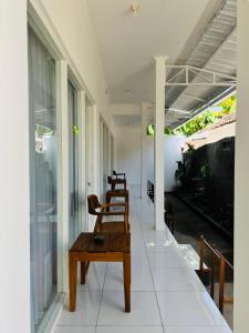 a room with chairs and a table and an aquarium at Ina Guesthouse in Lovina