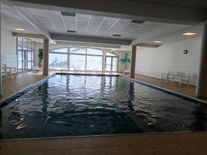a large swimming pool in a building with water at Hourquette in Bagnères-de-Bigorre