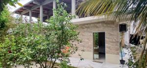a building with a bunch of trees in front of it at Pousada 48 Graus - Caldas do Jorro BA in Poço Redondo