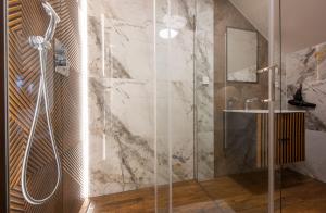 a bathroom with a shower and a sink at Hotel Tulipan in Tatranská Lomnica
