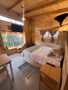 a bedroom with a bed in a log cabin at K m 6 River Lodge in Pucón +54 photos